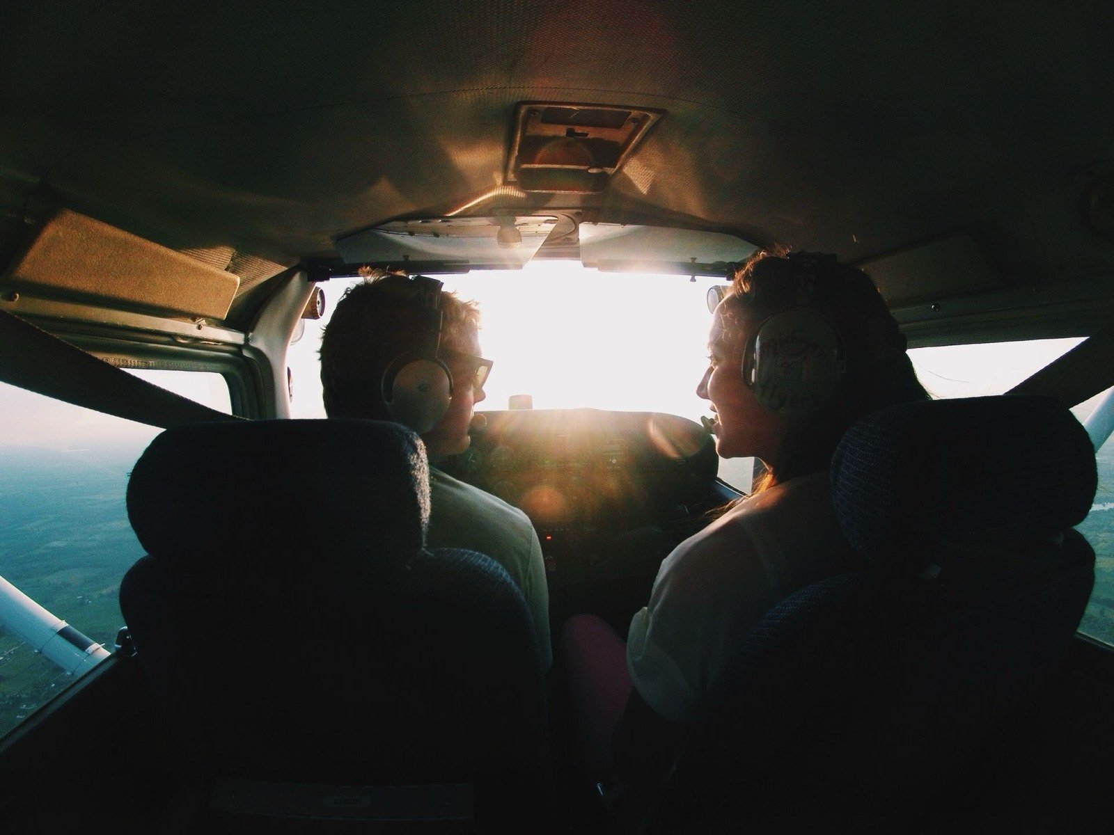 Two pilots flying at sunset